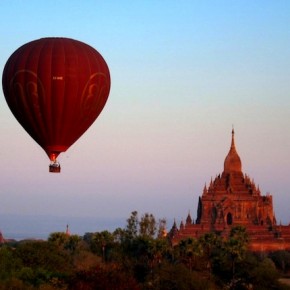 Balloon rising over Htilminlo Paho at dawn in Bagan, Burma.