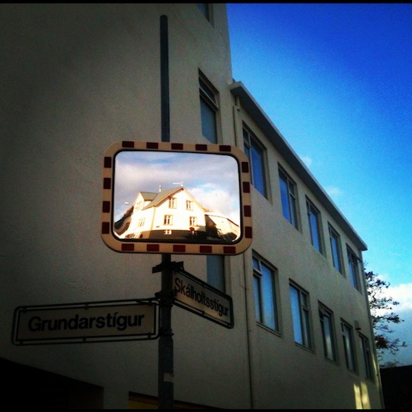 Reflected houses on a street mirror in Reykjavik